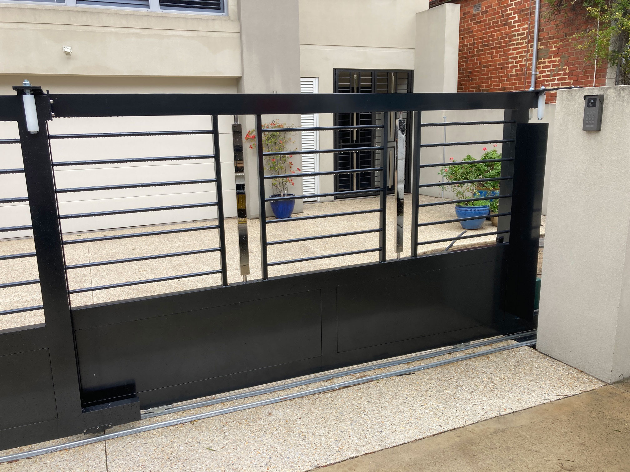 Custom Aluminium & Stainless Steel Electric Telescopic Vehicle Gate. Constructed of 19od Round Aluminium Horizontal Tube& Hi Polished Stainless Steel 50 x 25 Verticals. Aluminium Powdercoated in Black Onyx. Automated with the Centsys D5 Evo Low Voltage Gate Motor Kit. & a Fermaz Video Intercom upgraded with Phone Capabilities.Contact Western Automate today for a free, no-obligation quote - 08 6499 2812 | sales@westernautomate.com.au | https://westernautomate.com.au